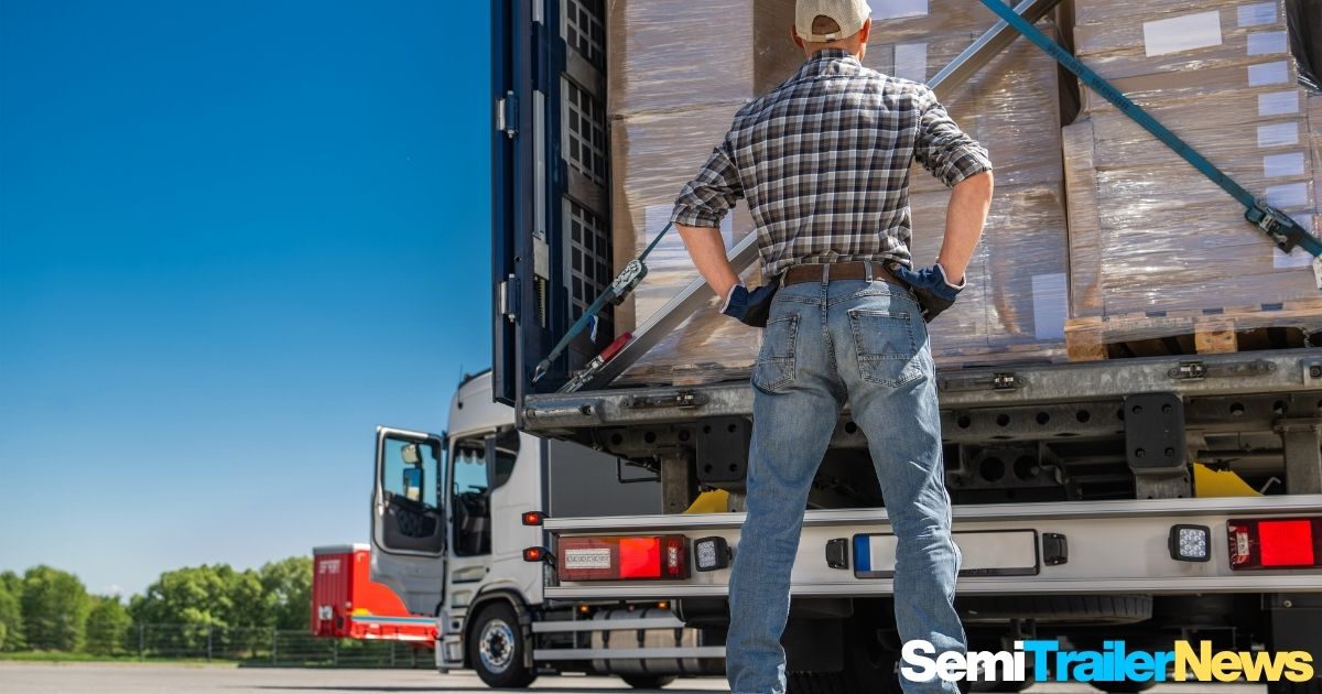 Port workers preparing semi trailers for global shipment